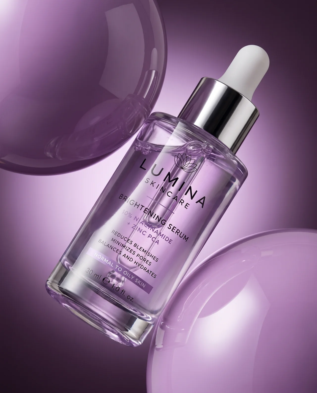 Beauty hero — Lumina brightening serum among purple glass spheres
